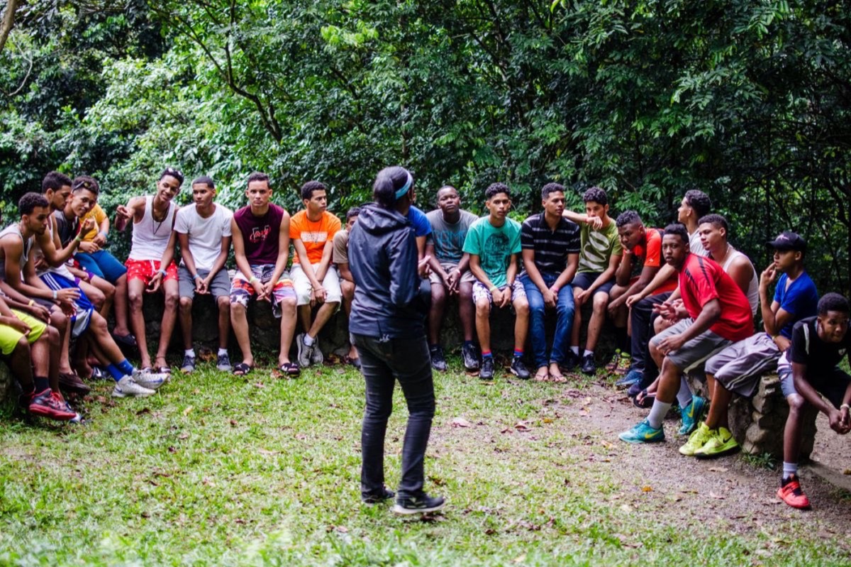 A group of young people sitting together outdoors during a group session